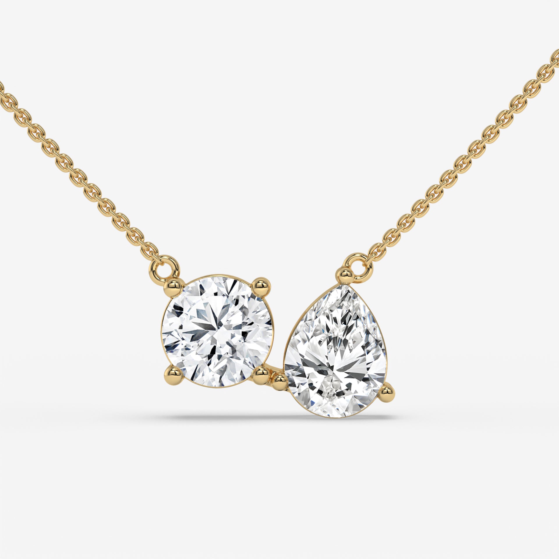 Pear and Round Duet Pendant in Yellow Gold